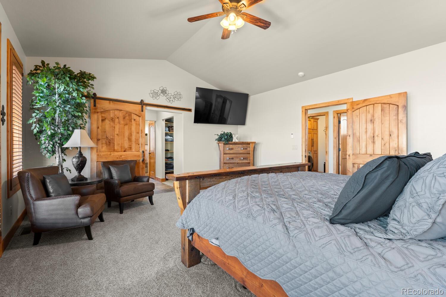60075 Oak Grove Road Montrose, CO 81403 - Photo 17 of 50 a bedroom with a bed a couch and dresser