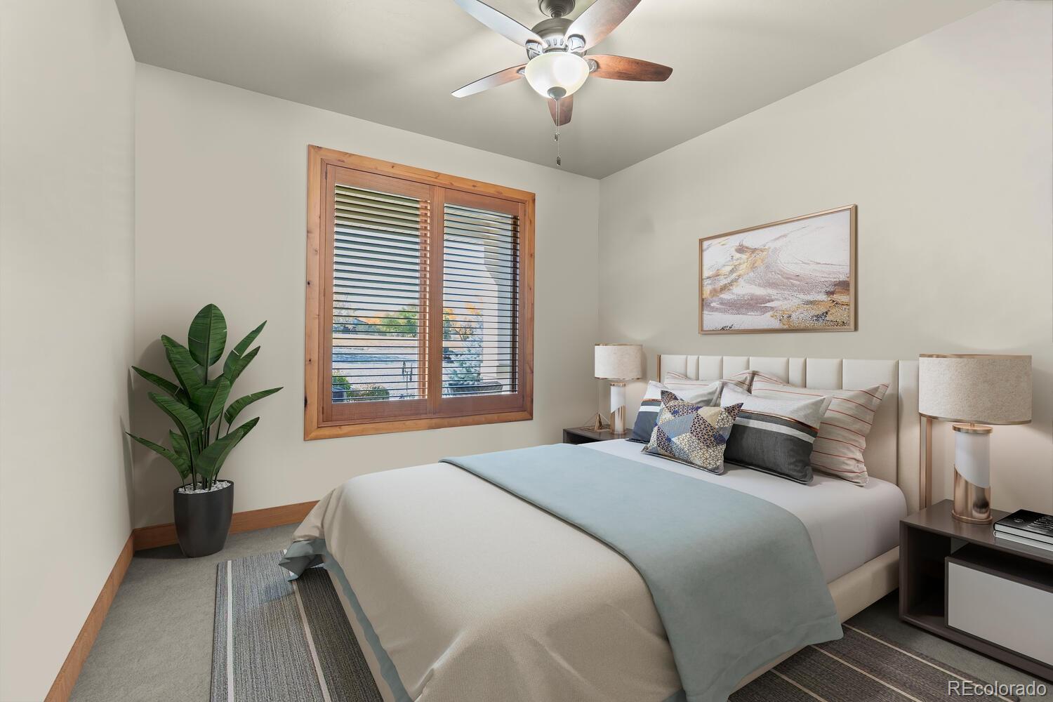 60075 Oak Grove Road Montrose, CO 81403 - Photo 20 of 50 a bedroom with bed and a chandelier