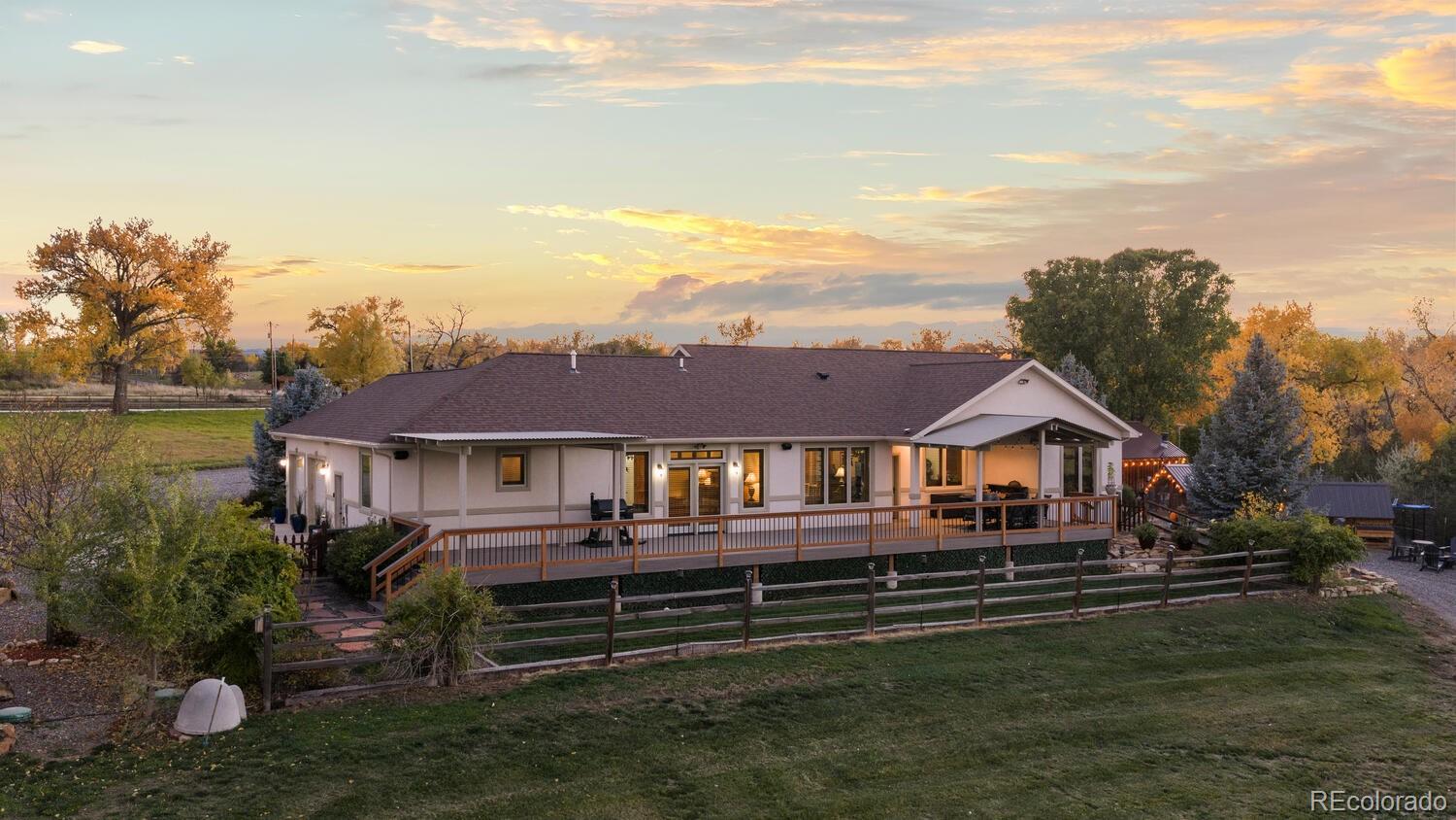 60075 Oak Grove Road Montrose, CO 81403 - Photo 25 of 50 a front view of a house with a garden and lake view