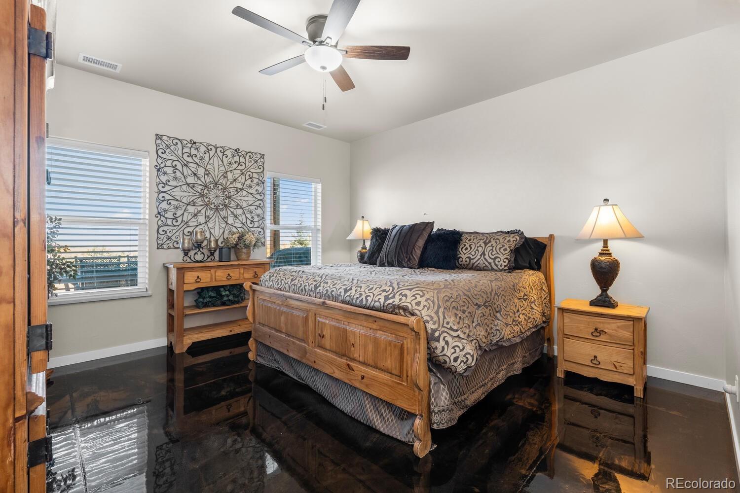 60075 Oak Grove Road Montrose, CO 81403 - Photo 34 of 50 a bedroom with a bed and a chandelier