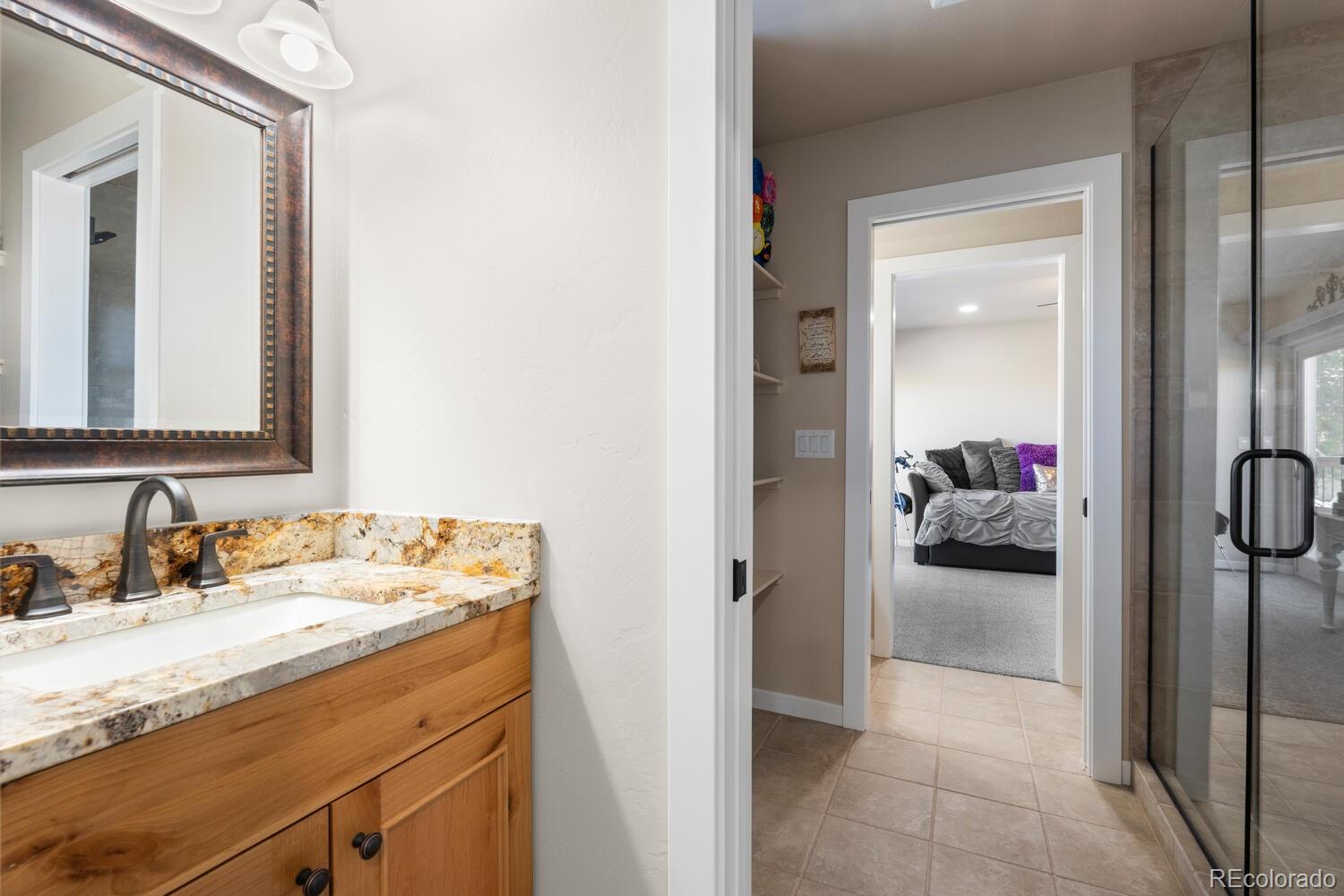 60075 Oak Grove Road Montrose, CO 81403 - Photo 38 of 50 a en suite bathroom with a sink and a mirror