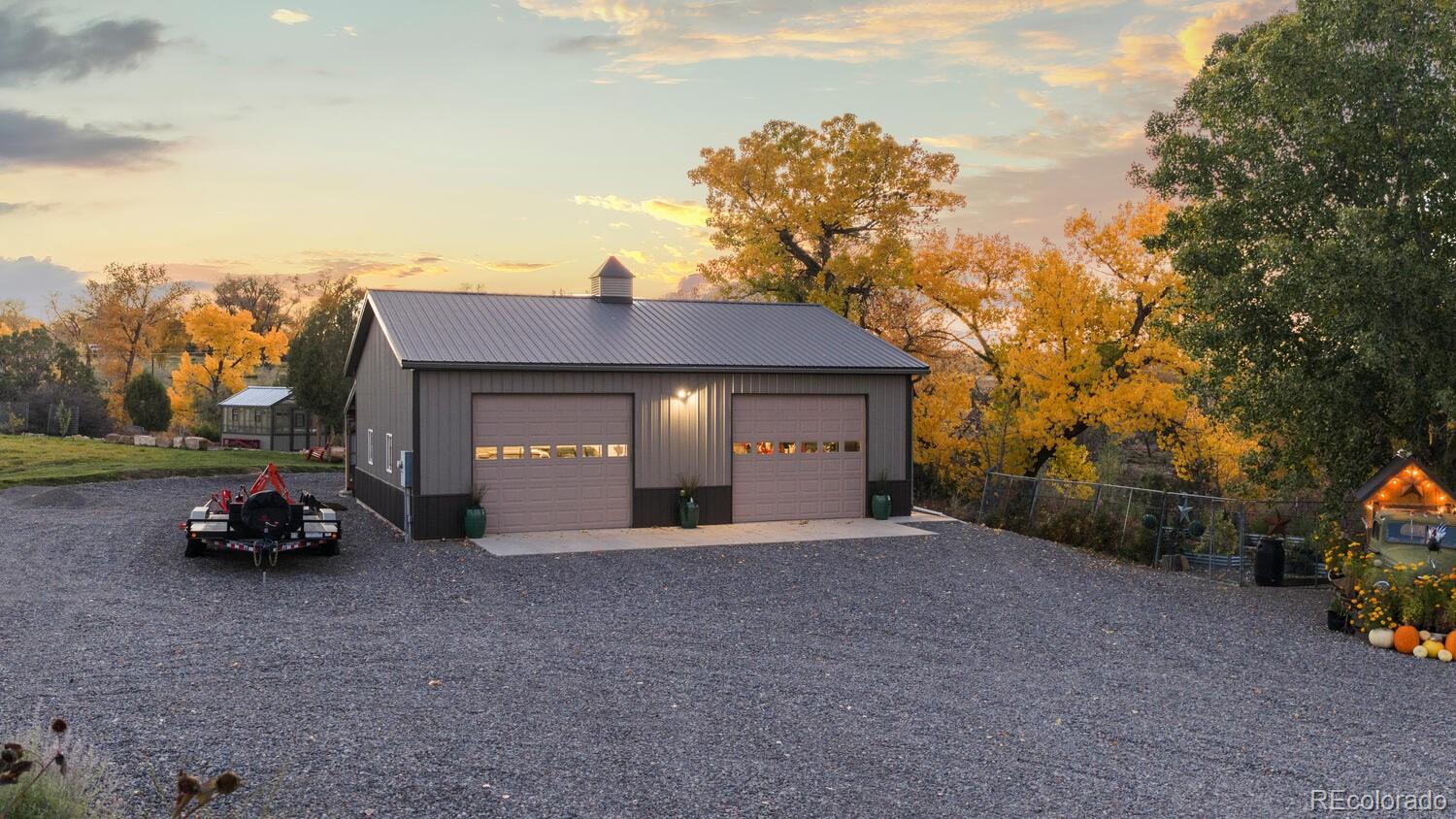 60075 Oak Grove Road Montrose, CO 81403 - Photo 42 of 50 a view of a house with a yard and a car parked