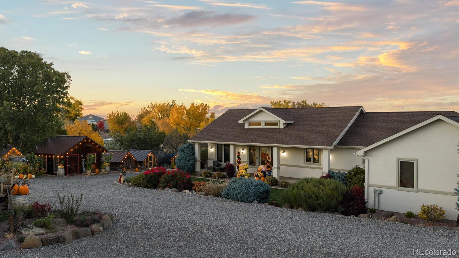 60075 Oak Grove Road Montrose, CO 81403 - Photo 9 of 50 a front view of a house with a garden and pathway