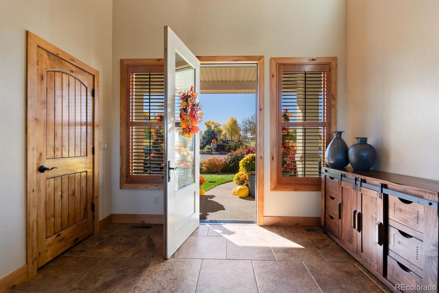 60075 Oak Grove Road Montrose, CO 81403 - Photo 10 of 50 a view of an entryway with wooden floor and windows