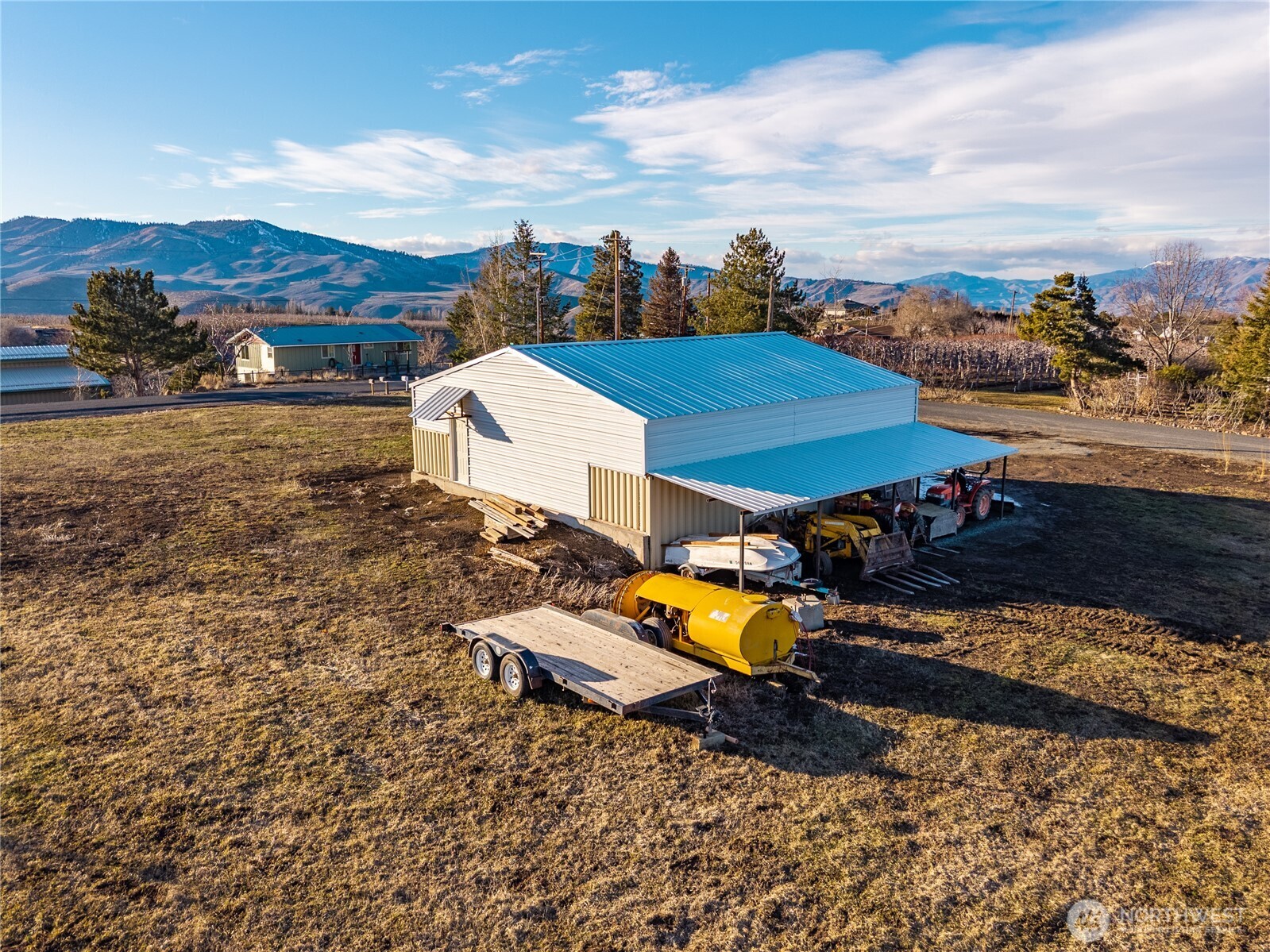 4105 Jim Smith Road Wenatchee, WA 98801 - Photo 4 of 9 an aerial view of a house with a garden and mountain view in back
