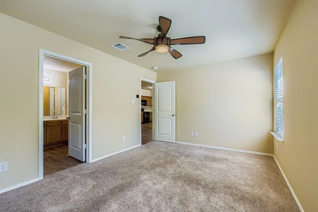 an empty room and chandelier fan