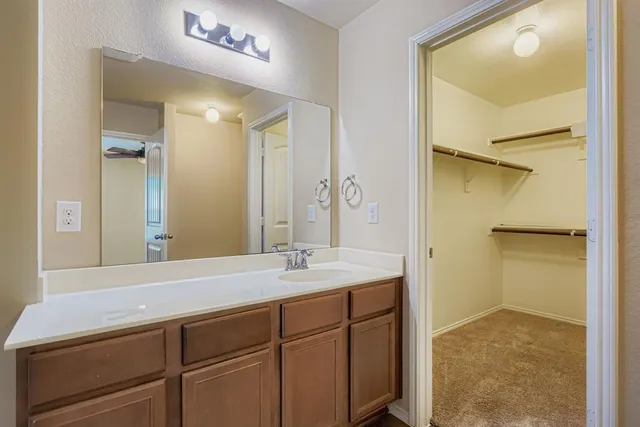 a bathroom with a granite countertop sink mirror and double