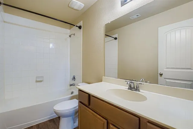 a bathroom with a sink toilet vanity and shower