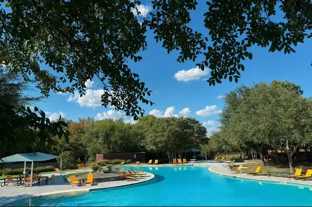 a view of a swimming pool with a table and chairs