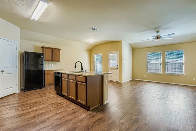 a view of kitchen with furniture and wooden floor
