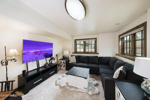 a living room with furniture a couch and a flat screen tv