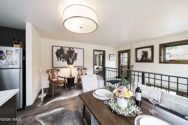 a living room with furniture and a dining table