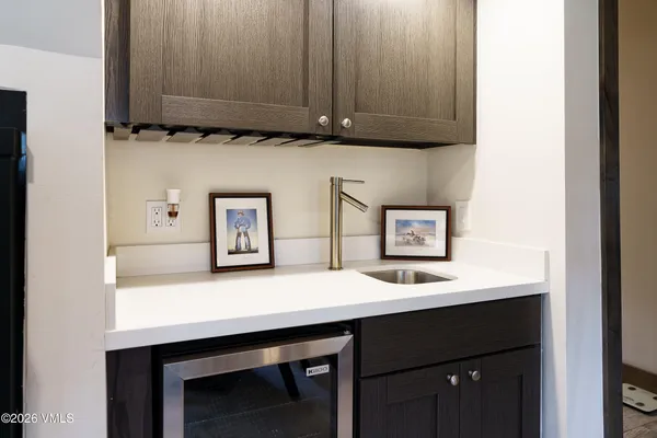 a room with a sink cabinets and wooden floor