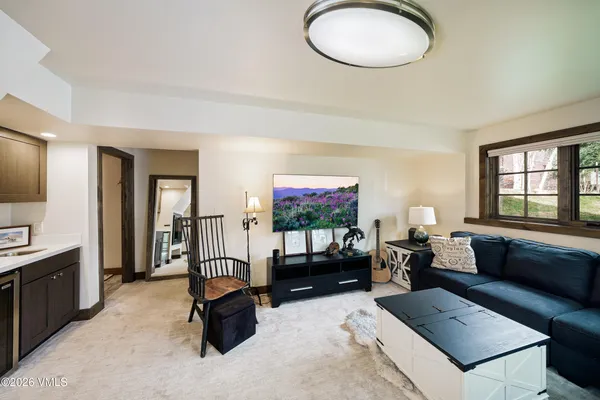 a living room with furniture a window and a flat screen tv