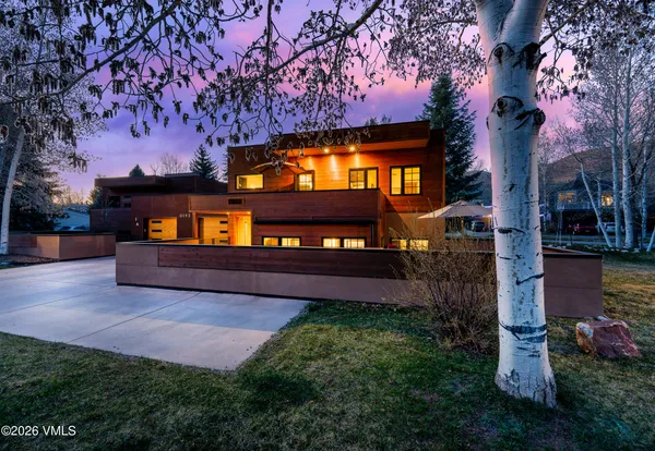 a house view with a sitting space and garden
