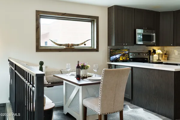 a living room with furniture a wooden floor and next to a window