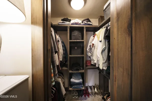 a large bed sitting in a bedroom next to a window