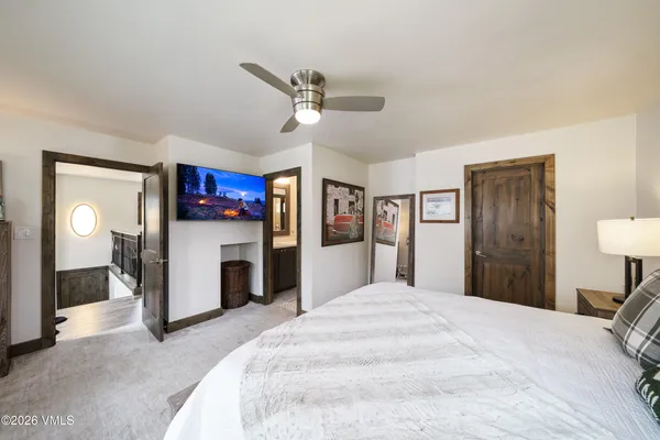 a bedroom with a bed and a mirror on dresser