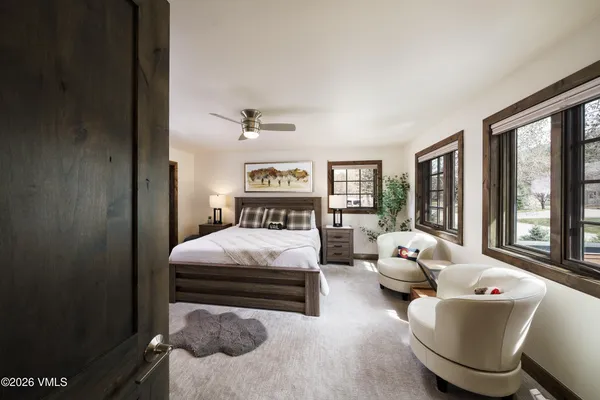 a bedroom with a bed and glass window