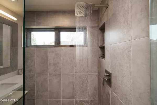 a bathroom with a glass shower door