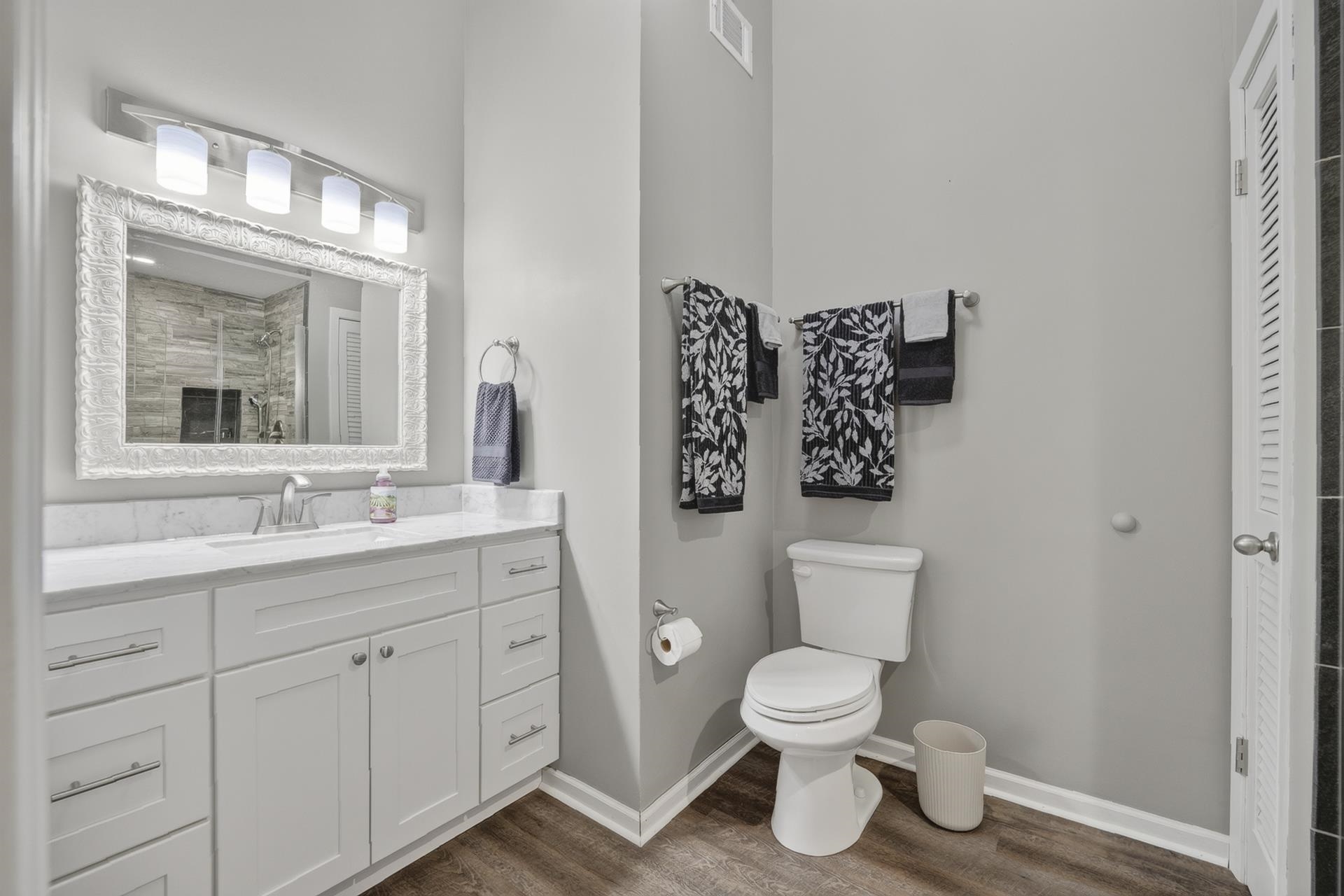 74 Driftwood Road Counce, TN 38326 - Photo 28 of 40 Bathroom featuring a spacious white vanity with a single sink, an ornate framed mirror, and a four-light fixture, granite countertop