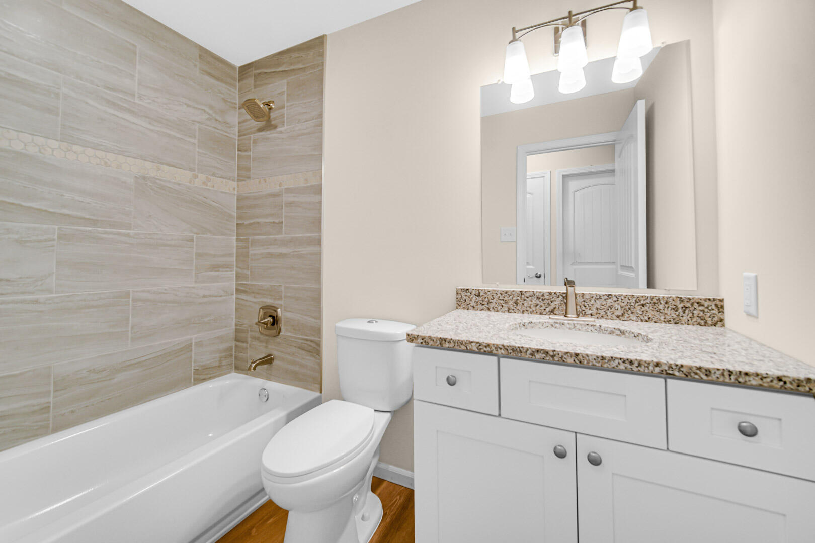 739 Fremont Road Valparaiso, IN 46385 - Photo 16 of 26 a bathroom with a granite countertop toilet a sink and bathtub