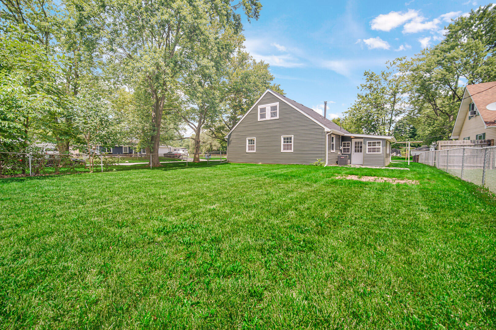 739 Fremont Road Valparaiso, IN 46385 - Photo 22 of 26 a view of a brick house with a big yard and large trees