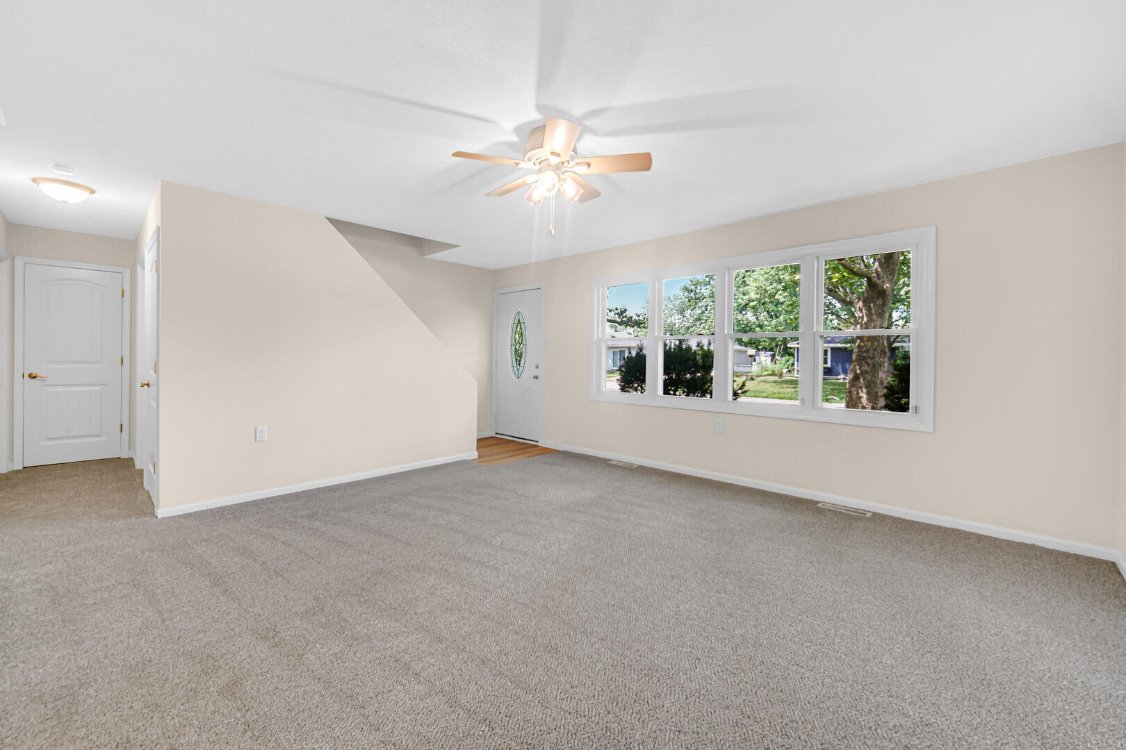 739 Fremont Road Valparaiso, IN 46385 - Photo 5 of 26 an empty room with windows and chandelier fan