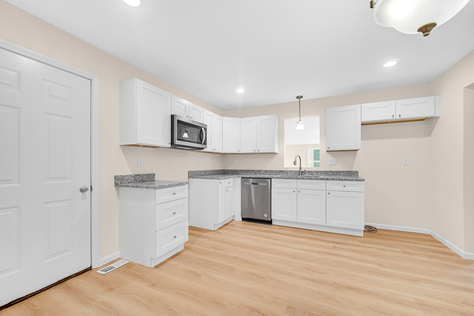 739 Fremont Road Valparaiso, IN 46385 - Photo 7 of 26 a large kitchen with granite countertop white cabinets and stainless steel appliances