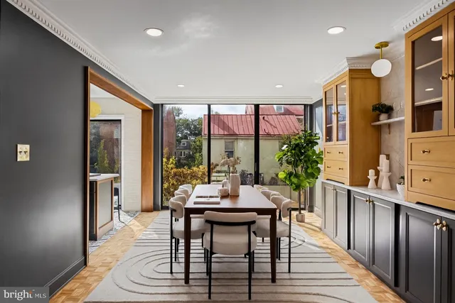 a dining room with furniture window and wooden floor