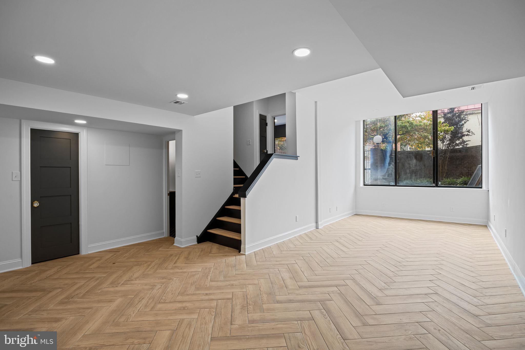 242 Locust Street Philadelphia, PA 19106 - Photo 42 of 62 a view of an empty room with wooden floor and a window