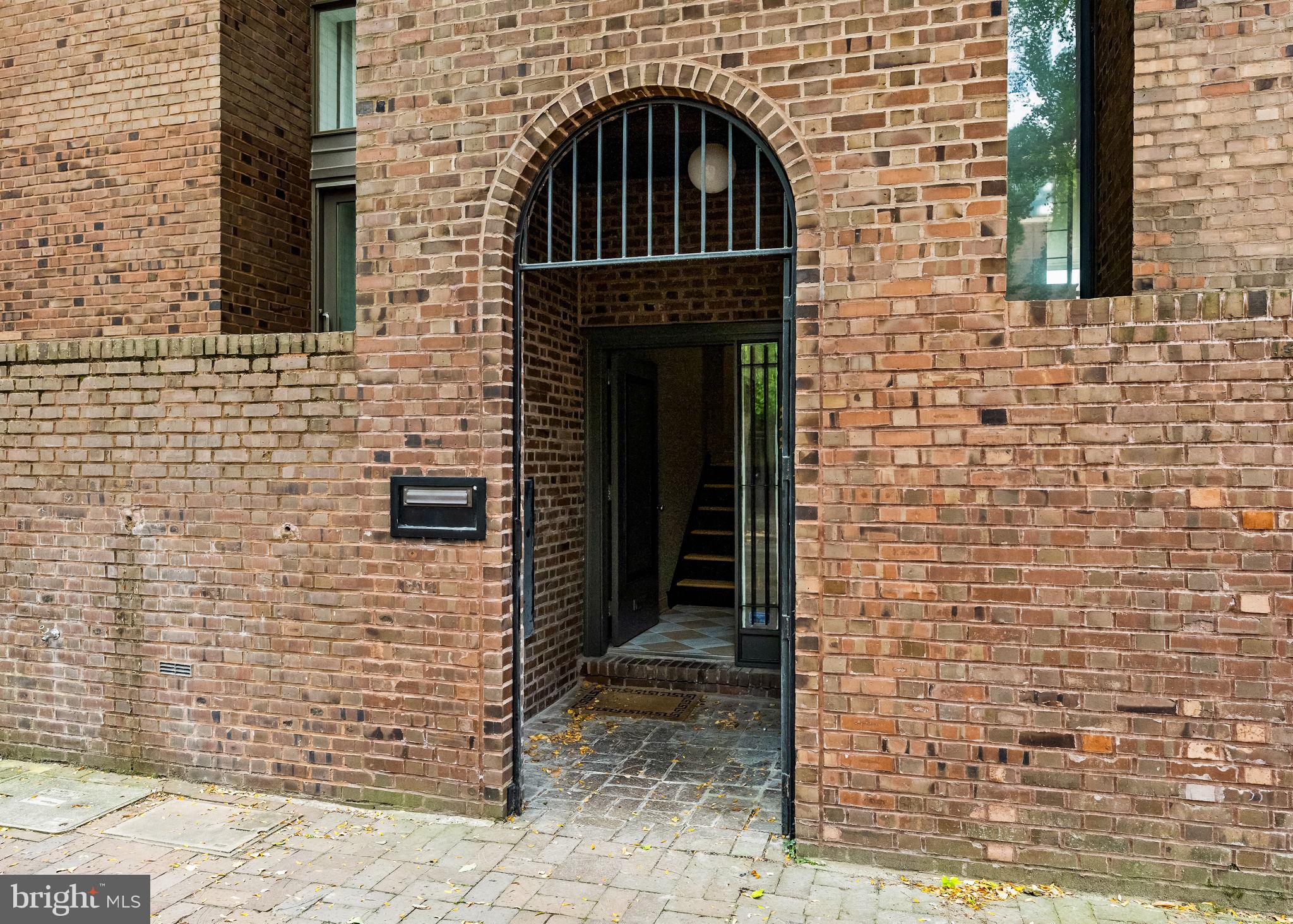 242 Locust Street Philadelphia, PA 19106 - Photo 58 of 62 a front view of a brick house with a door