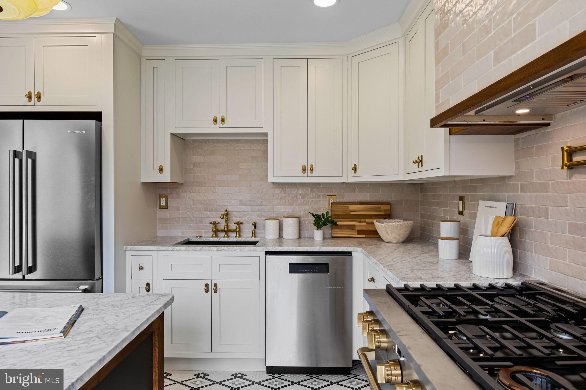 242 Locust Street Philadelphia, PA 19106 - Photo 8 of 62 a kitchen with stainless steel appliances granite countertop a sink stove and refrigerator