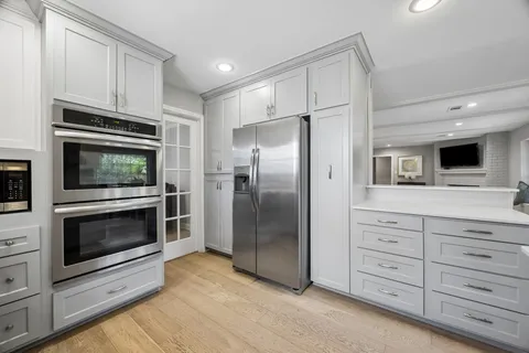 a kitchen with stainless steel appliances a stove a microwave and cabinets