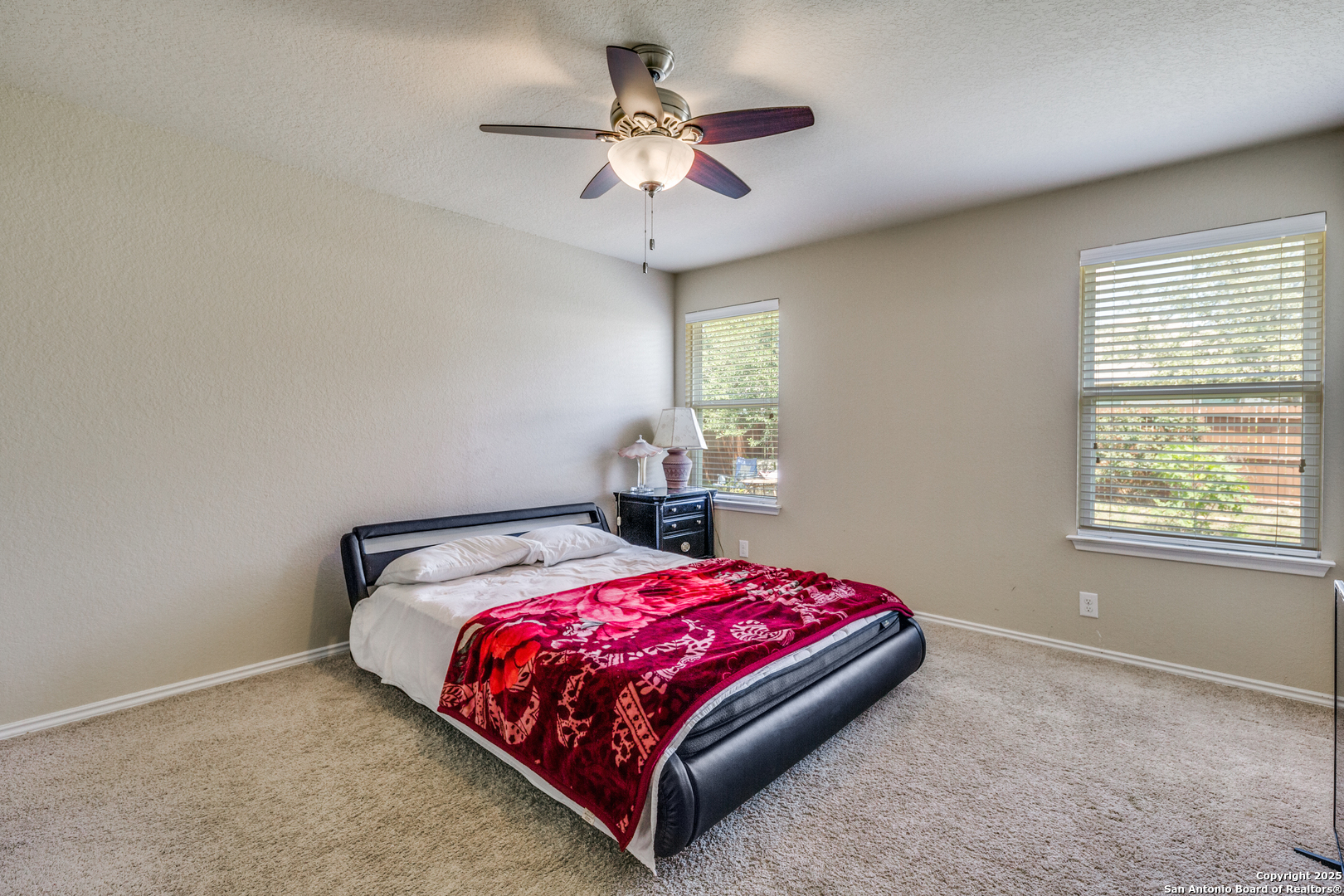 10415 Rhyder Ridge San Antonio, TX 78254 - Photo 12 of 25 a bedroom with a bed and a chandelier
