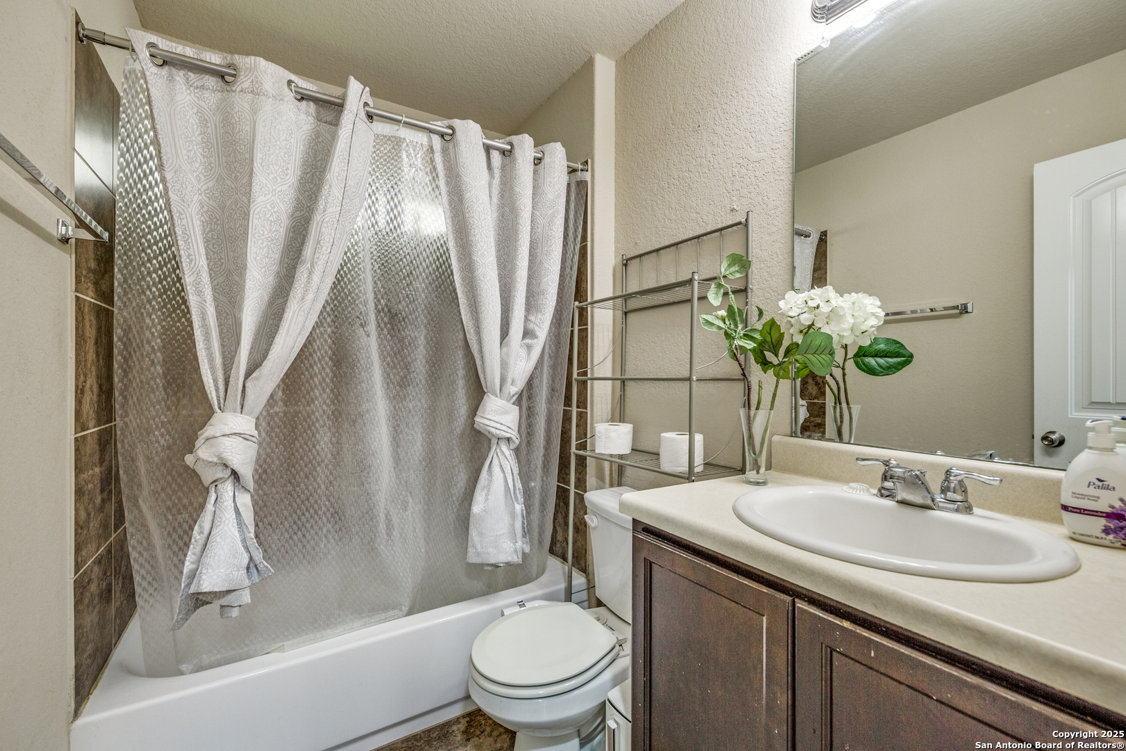10415 Rhyder Ridge San Antonio, TX 78254 - Photo 17 of 25 a bathroom with a sink toilet and shower