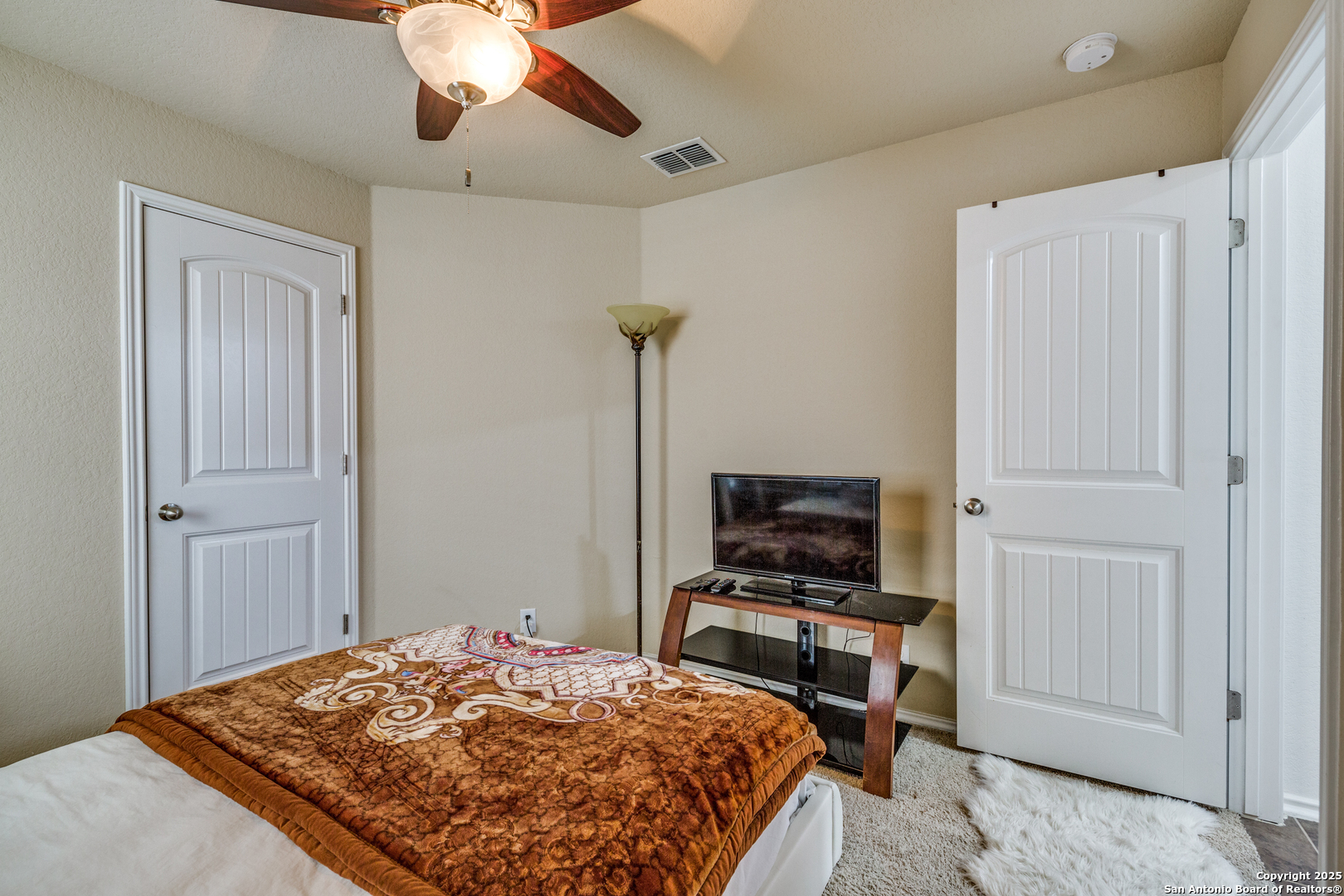 10415 Rhyder Ridge San Antonio, TX 78254 - Photo 23 of 25 a bedroom with a bed and a flat screen tv