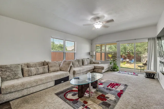a living room with furniture and a large window