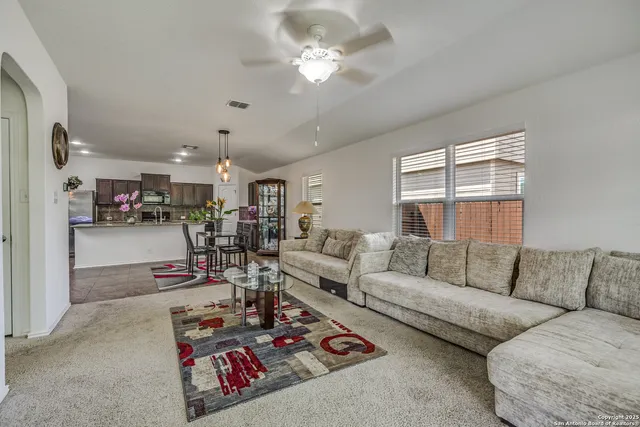 a living room with furniture and kitchen view