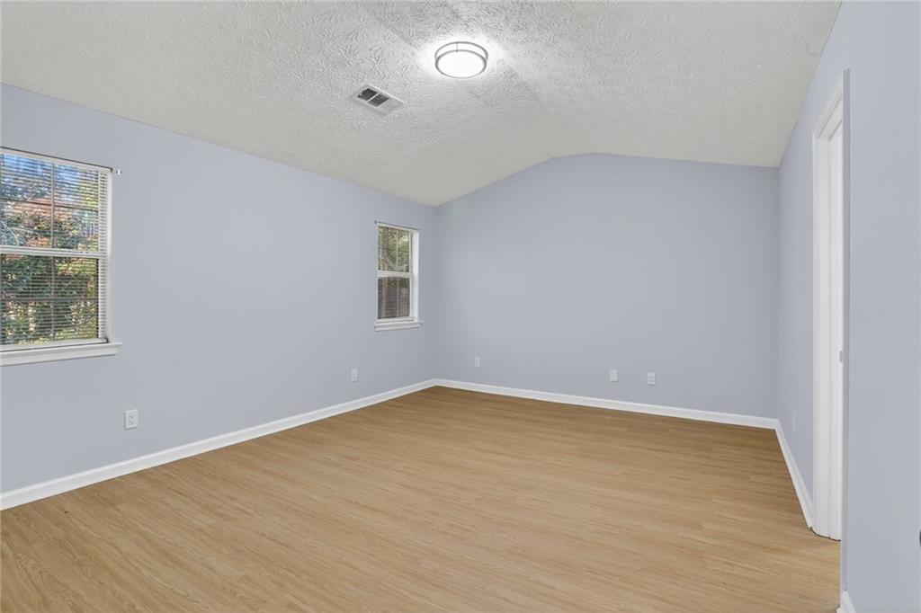 218 Nicki Court Hampton, GA 30228 - Photo 12 of 17 wooden floor in an empty room with a window