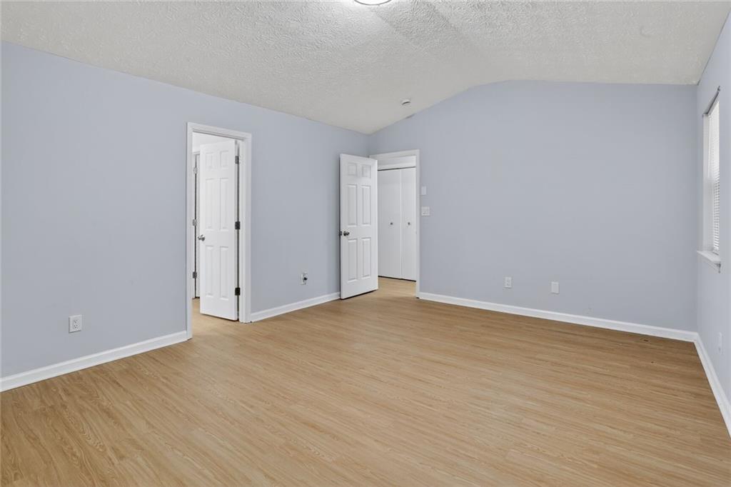218 Nicki Court Hampton, GA 30228 - Photo 13 of 17 a view of an empty room and wooden floor