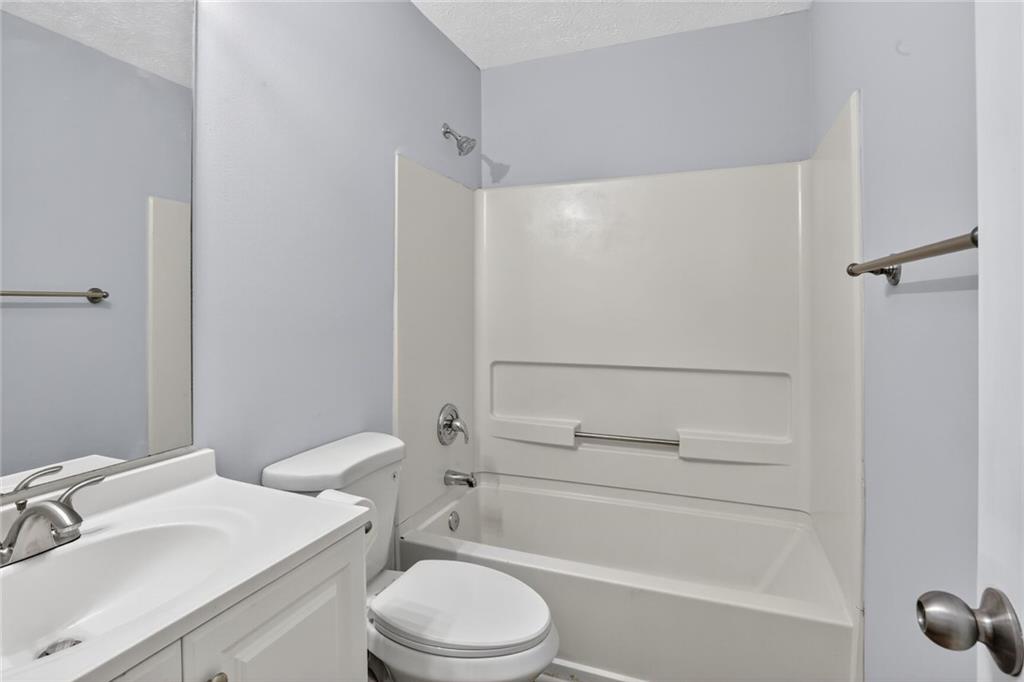 218 Nicki Court Hampton, GA 30228 - Photo 9 of 17 a bathroom with a sink toilet and shower