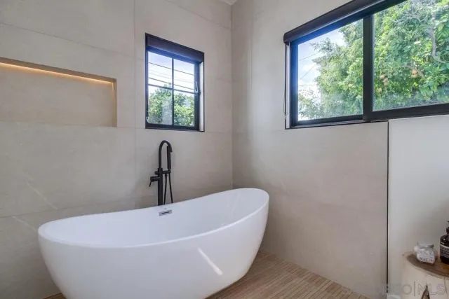 a white bath tub sitting in a bathroom