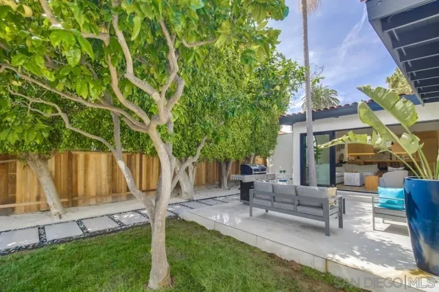 a view of a house with a yard and sitting area