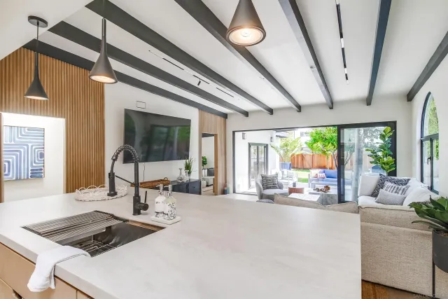 a living room with furniture and a floor to ceiling window