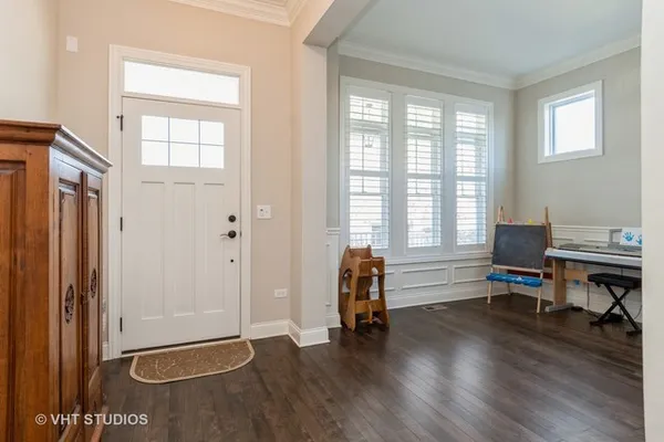 an empty room with piano table and windows