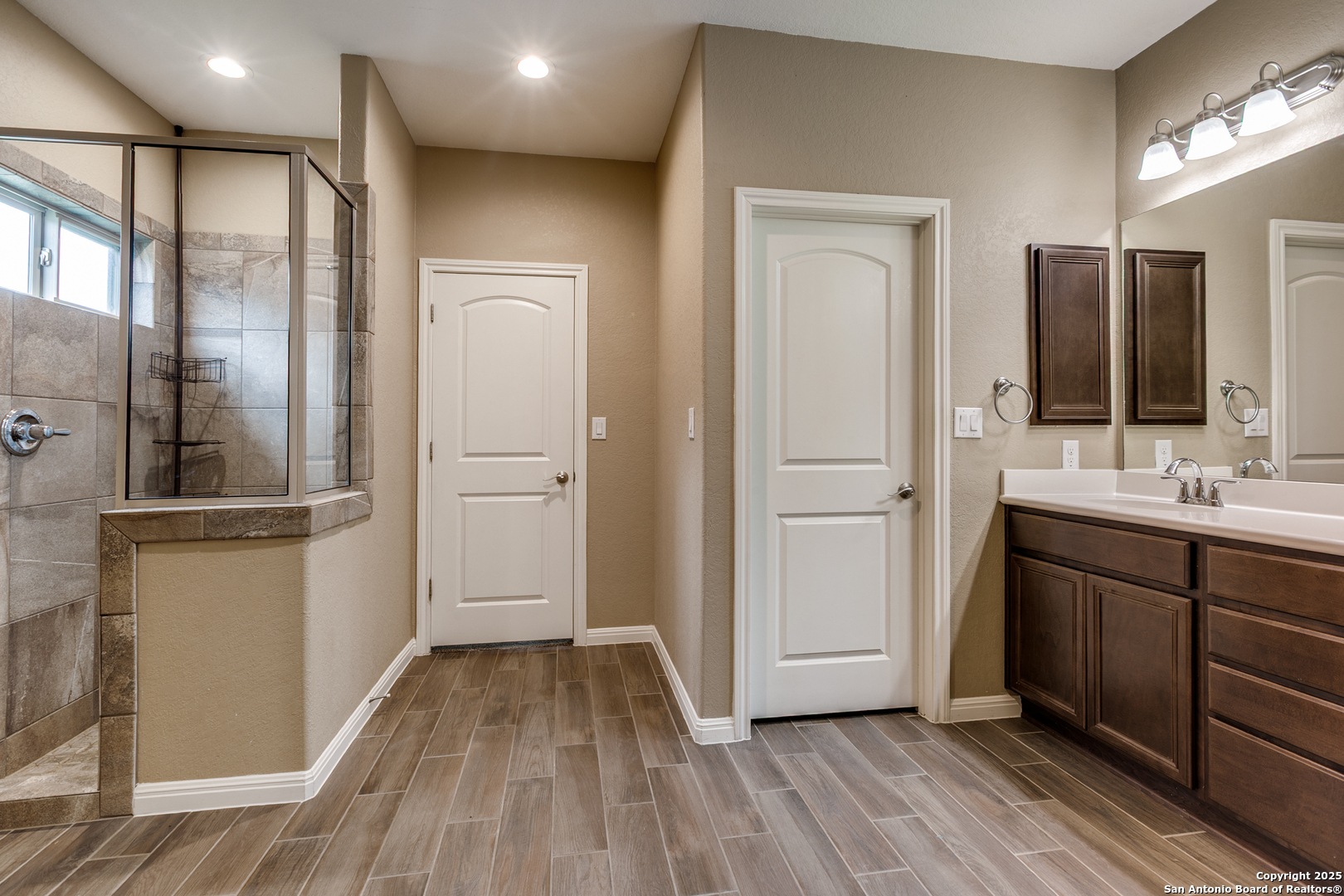 305 Iron Gate Pleasanton, TX 78064 - Photo 13 of 25 a bathroom with a sink and a mirror