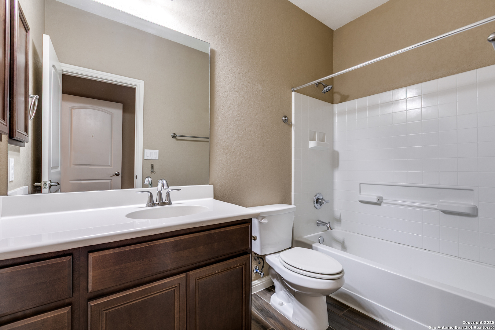 305 Iron Gate Pleasanton, TX 78064 - Photo 18 of 25 a bathroom with a sink a toilet a mirror and shower