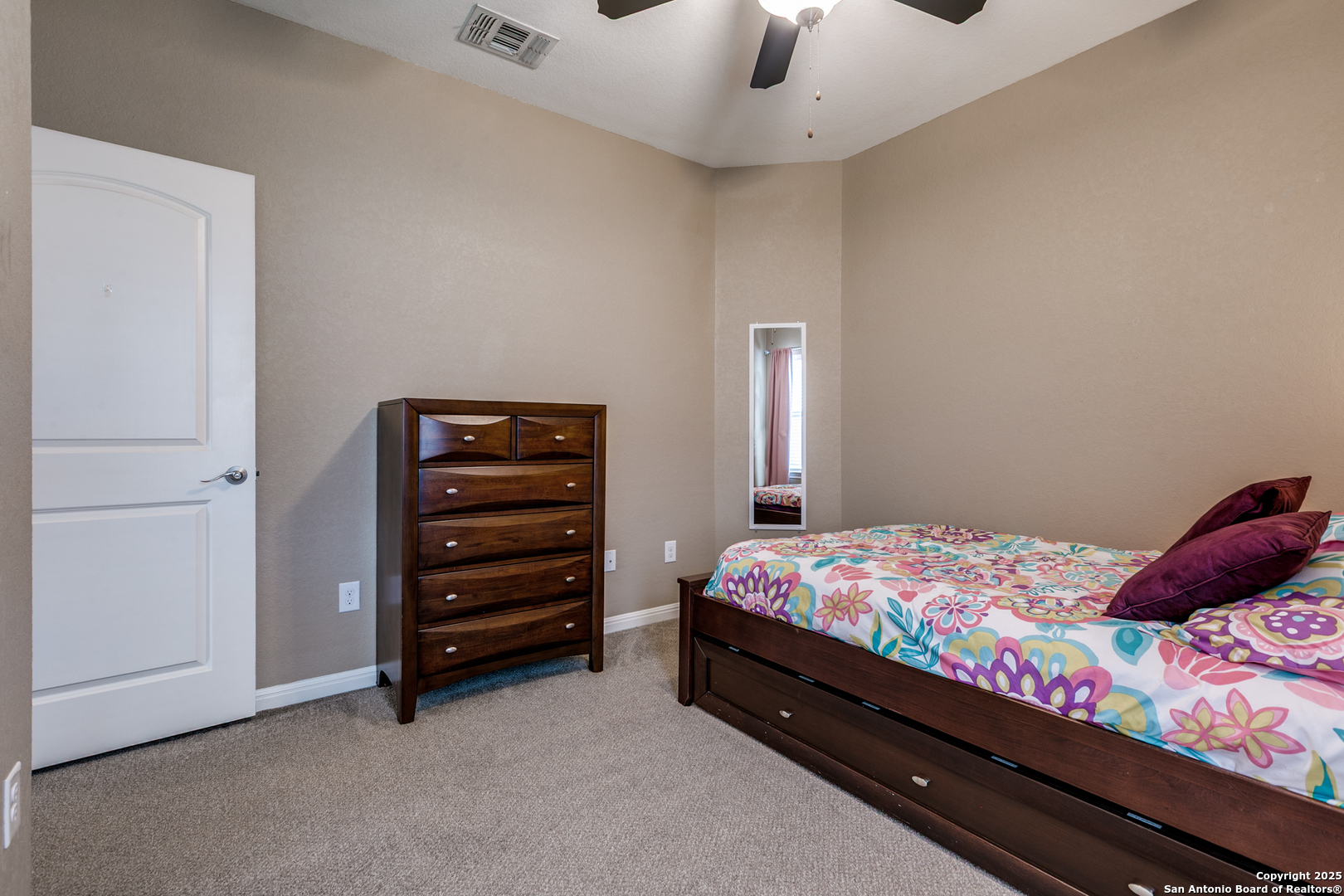 305 Iron Gate Pleasanton, TX 78064 - Photo 21 of 25 a bedroom with a bed and a cabinets