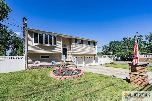 a front view of a house with a yard table and chairs